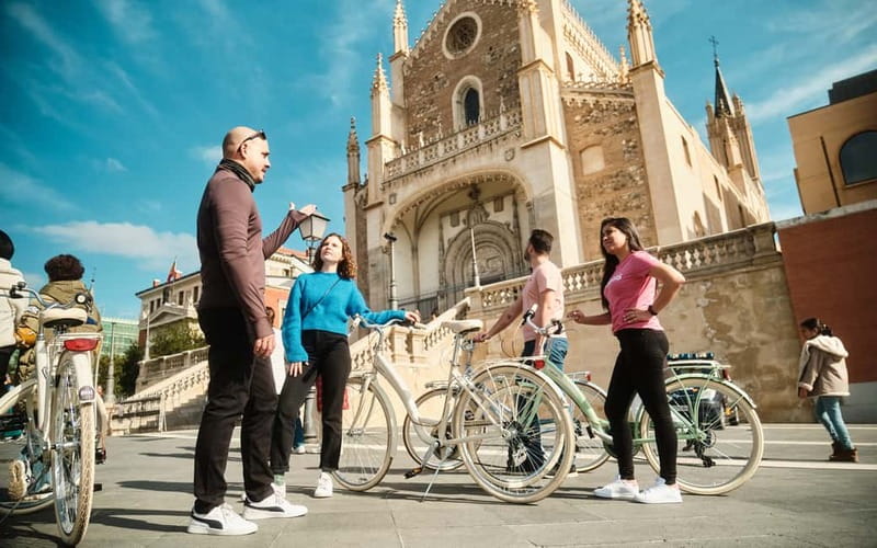 Madrid: Highlights Guided Vintage Bike Tour and Tapas Option - Las Letras Quarter and Puerta del Sol: where the stories are short and sweet