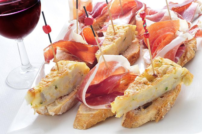 Madrid Tapas Experience Walking Tour - Stop 1 SANDEMANs New Europe Madrid: paella, jamón, and wineskin sipping